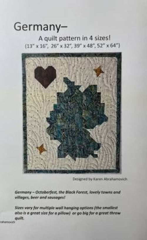 A quilt pattern cover for 'Germany' by Karen Abrahamovich, showing a quilt design of the map of Germany with a dark brown heart and gold stars on a white background, with size options listed at the top.